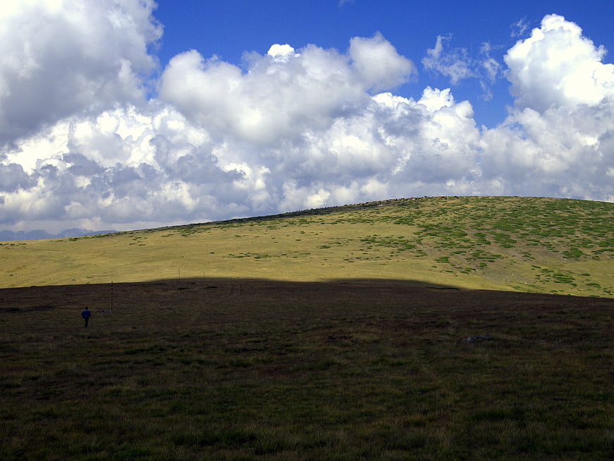 Lone Hiker in Shadowed Rila Mountains Landscape