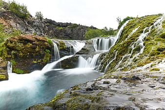 Mossy Waterfall Cascading Over Rocks in Nature