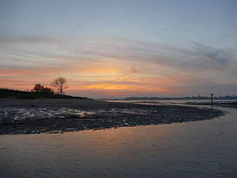 Serene Sunset Over Wadden Sea Mudflats and Dike