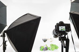 Professional photography studio setup with camera and wine