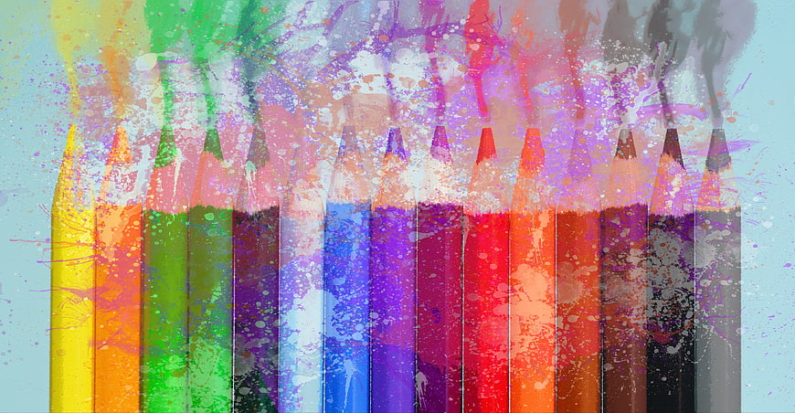 Colorful pencils with vibrant paint splatter texture background