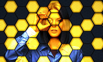 Woman with magnifying glass over yellow hexagon honeycomb pattern