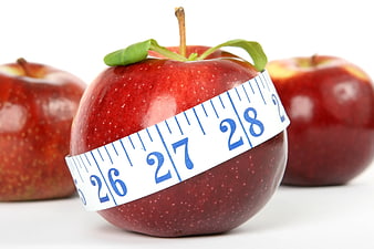 Red apple with measuring tape for diet and nutrition
