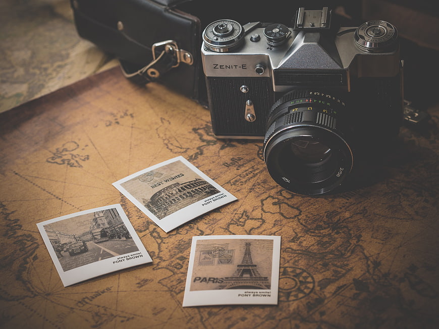 Vintage Zenit Camera and Paris Postcards on Old Map