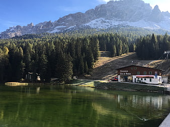 Scenic Dolomites Lake with Cable Car Station and Forest