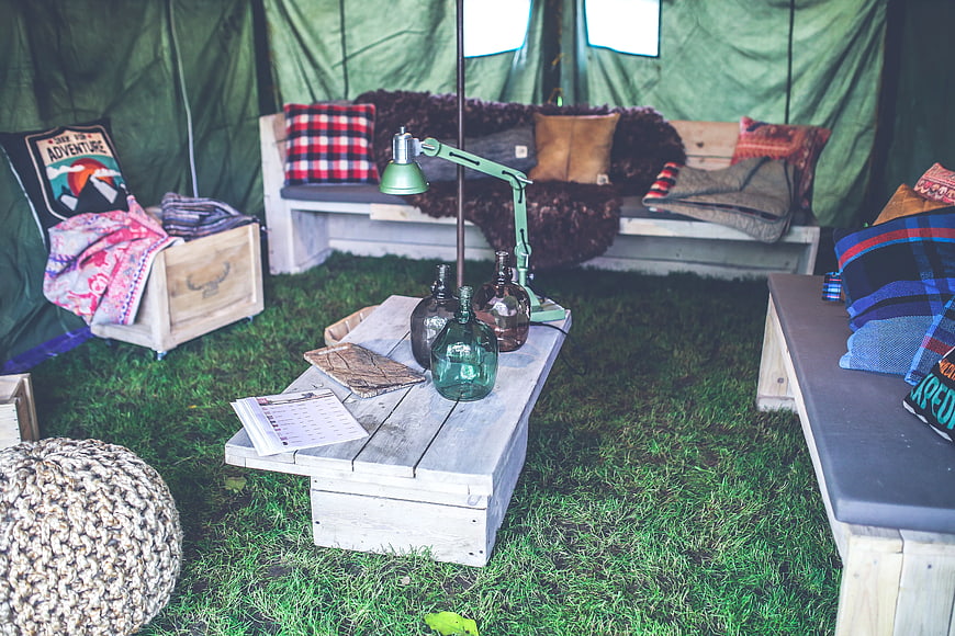 Cozy Glamping Tent Interior with Wooden Furniture and Decor