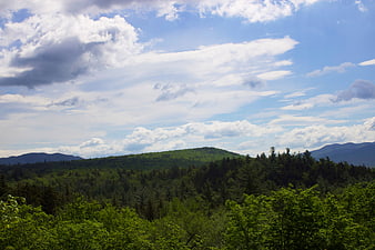 Scenic Green Mountain Landscape with Blue Sky and Clouds
