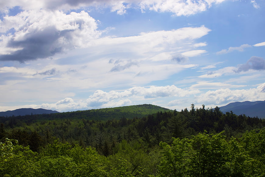 Scenic Green Mountain Landscape with Blue Sky and Clouds