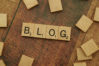 Wooden Scrabble Tiles Spelling Blog on Textured Background