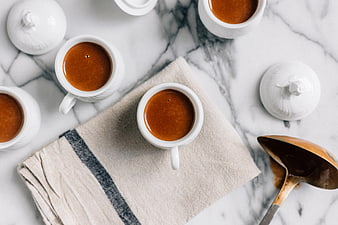 Overhead view of espresso cups on marble table