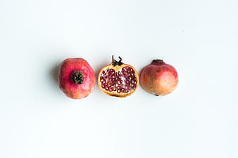 Fresh pomegranates on white background top view
