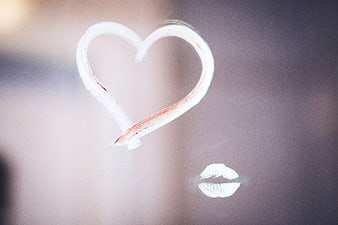 Heart drawn with lipstick on foggy glass
