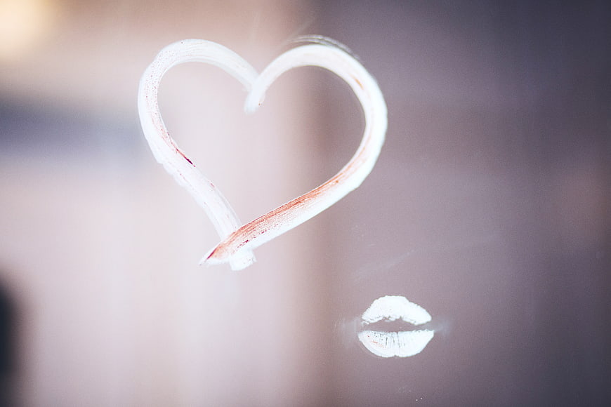 Heart drawn with lipstick on foggy glass