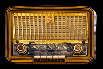 Vintage yellow Philips Halletta tube radio isolated on black