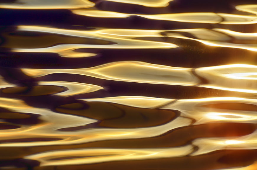 Abstract golden liquid waves with shiny texture background