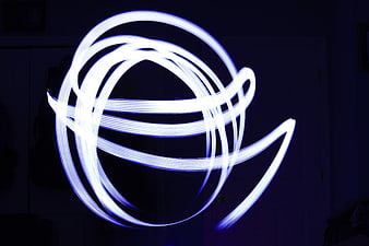 Abstract Blue Light Painting Swirls in Dark Room