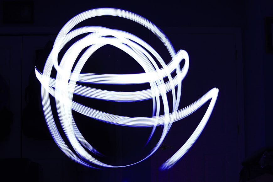Abstract Blue Light Painting Swirls in Dark Room