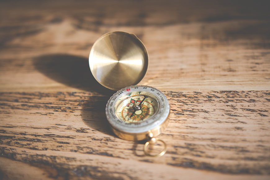 Vintage Brass Compass on Rustic Wooden Table