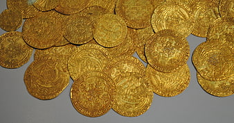 Collection of antique gold coins on gray background