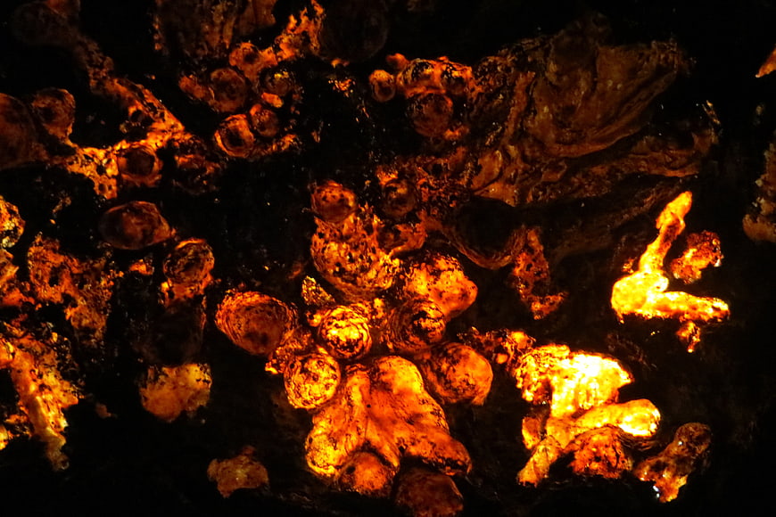 Glowing orange mineral formations on black background