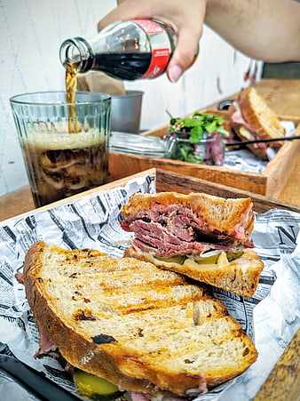 Toasted pastrami sandwich with soda pour