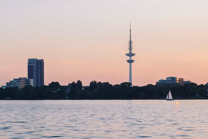 Hamburg TV Tower and Harbor at Sunset with Sailboat