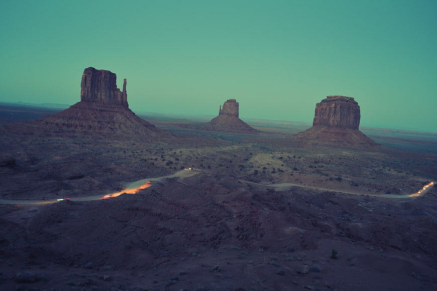 Monument Valley Buttes at Dusk with Car Headlights