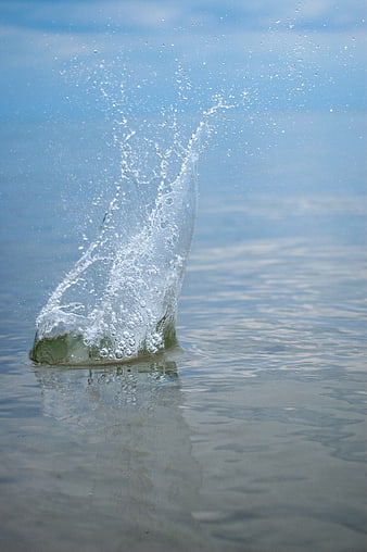 Dynamic Water Splash Rising from Calm Blue Lake Surface