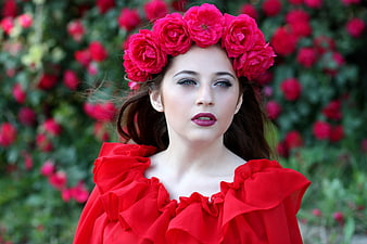 Woman in red dress with rose crown in garden