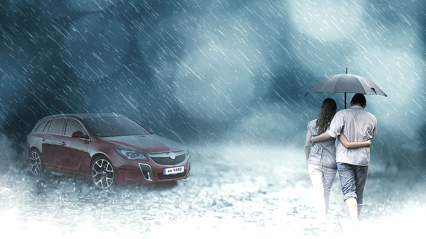 Couple under umbrella walking in rain near red car