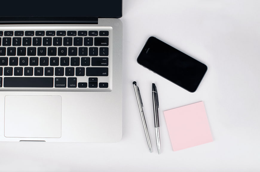 Minimalist Workspace Flat Lay With Laptop, Smartphone, Pens, And Sticky Notes