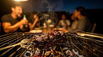 Grilled Kebabs on BBQ Grill with Friends Dining Background