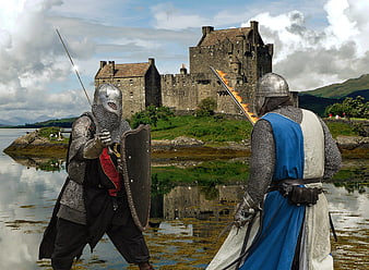 Medieval knights fighting with swords in front of a castle