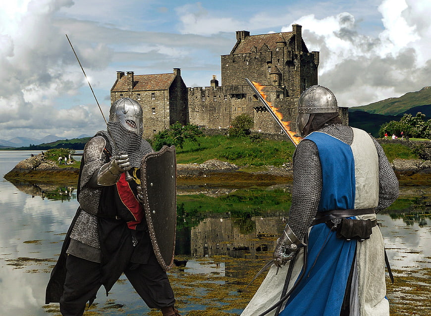Medieval knights fighting with swords in front of a castle