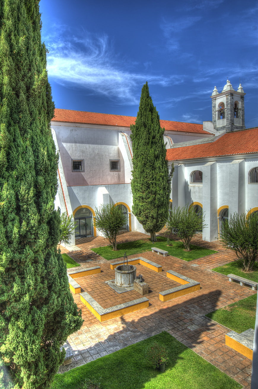 Sunlit courtyard of historic Portuguese monastery with fountain