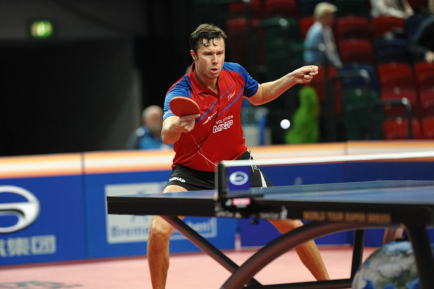 Male Table Tennis Player In Action During Indoor Tournament