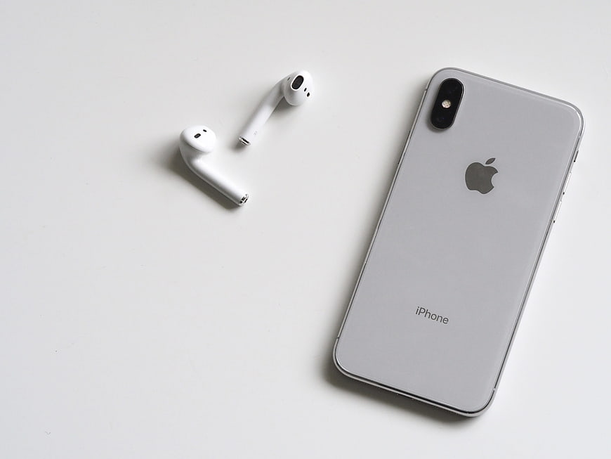 White iPhone X and AirPods on Minimal White Background