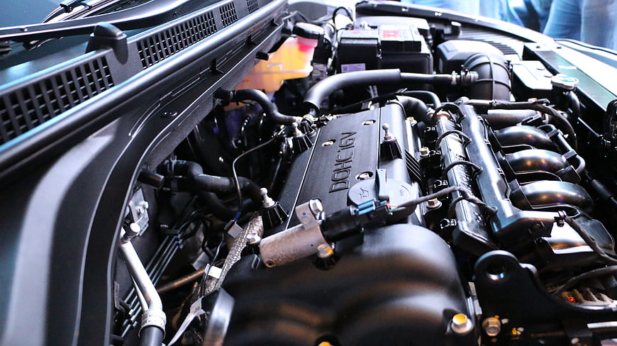 Close-up of car engine bay with DOHC 16V valve cover