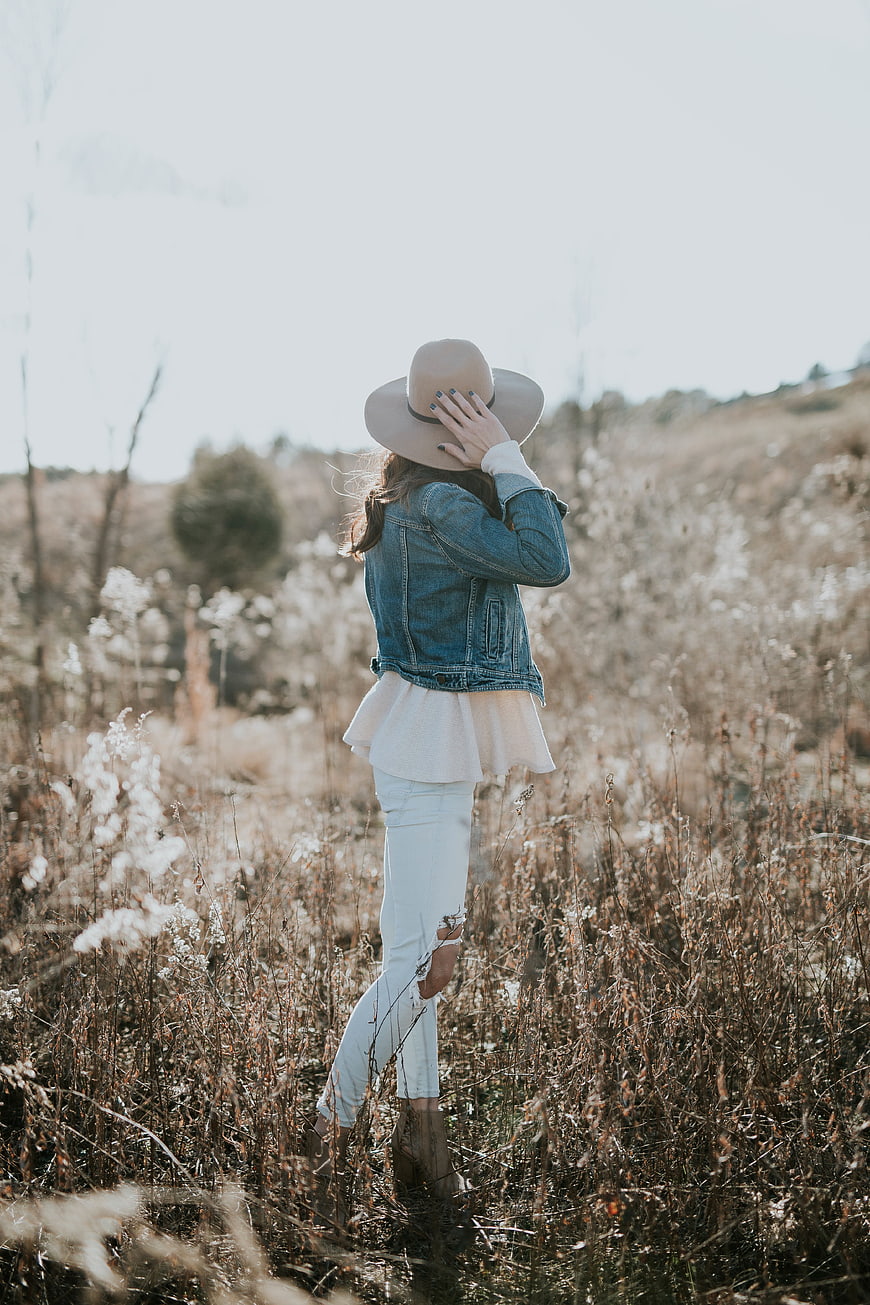 Woman in Denim Jacket and Hat in Dry Field