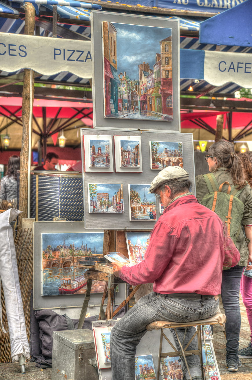 Street artist painting Paris scenes in Montmartre