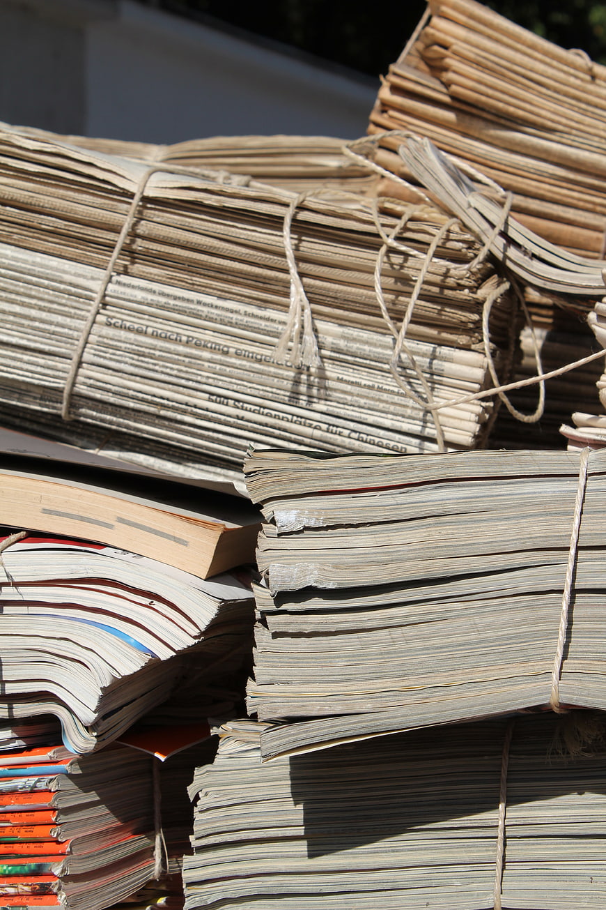 Stacks of bundled old newspapers and magazines for recycling