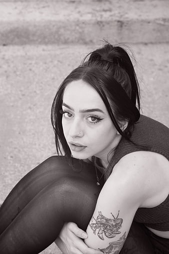 Black and white portrait of young woman with tattoo