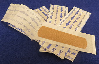 Sterile adhesive bandages on blue background