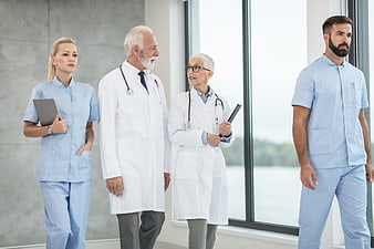 Diverse medical team standing in hospital corridor