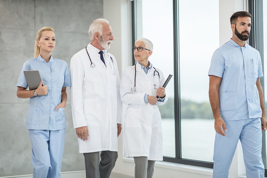 Diverse medical team standing in hospital corridor