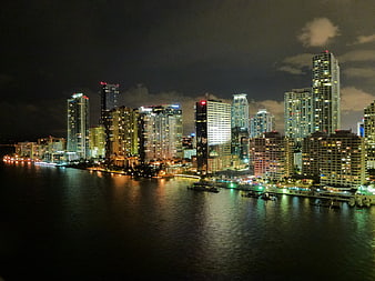 Miami Beach Skyline at Night with City Lights Reflecting on Water