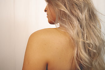 Close-up of Woman's Shoulder and Blonde Hair