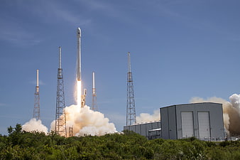 SpaceX Falcon 9 rocket launch from Cape Canaveral with smoke and fire