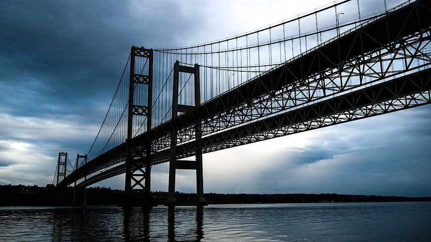 Dramatic Low Angle View of Double-Decker Suspension Bridge Over Water