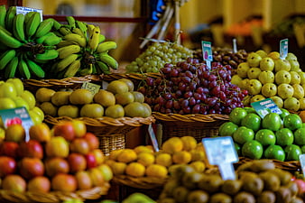 Colorful Fresh Fruit Display In Wicker Baskets At Local Market